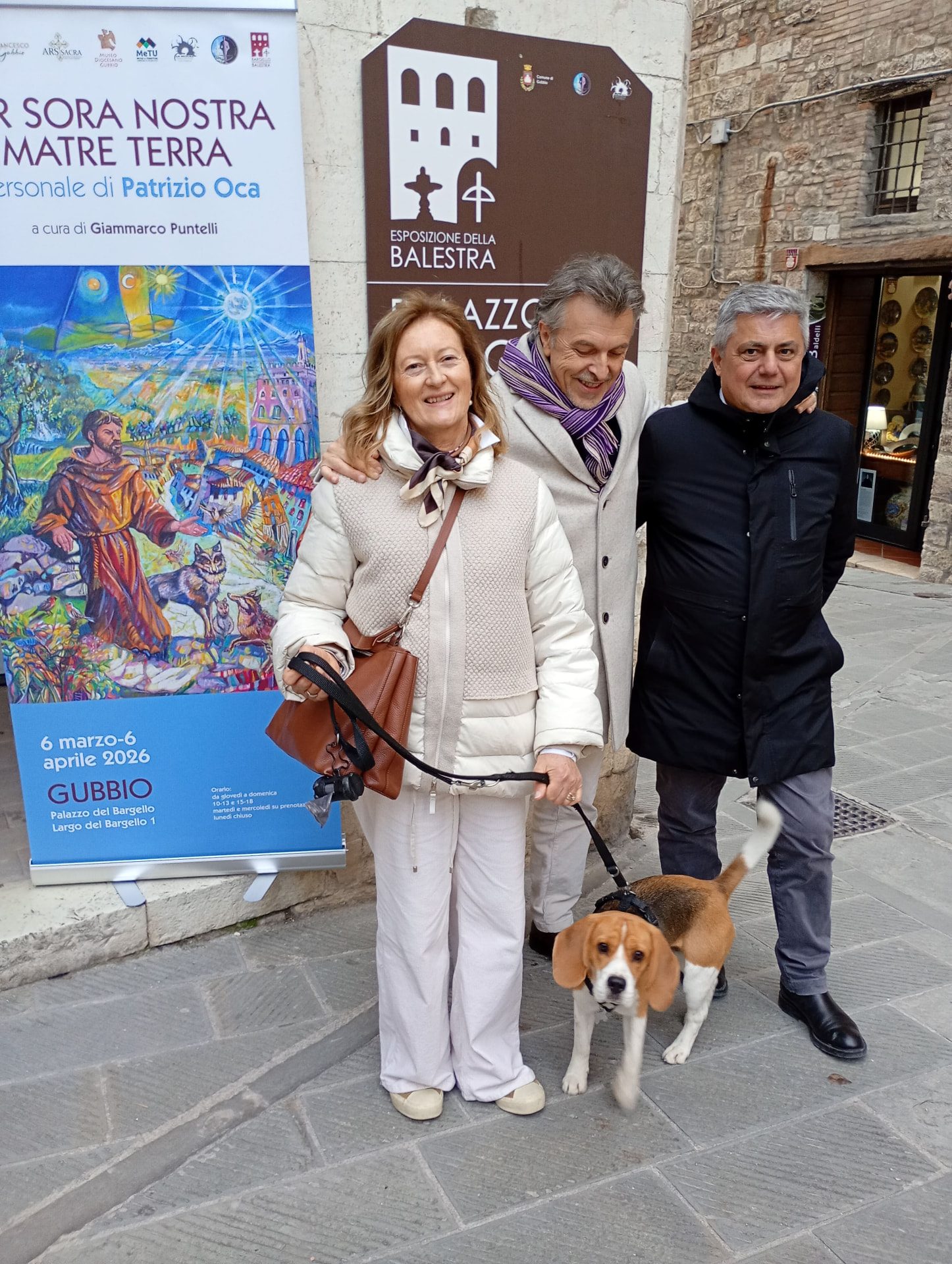 L'artista con ospiti davanti alla locandina della mostra a Gubbio